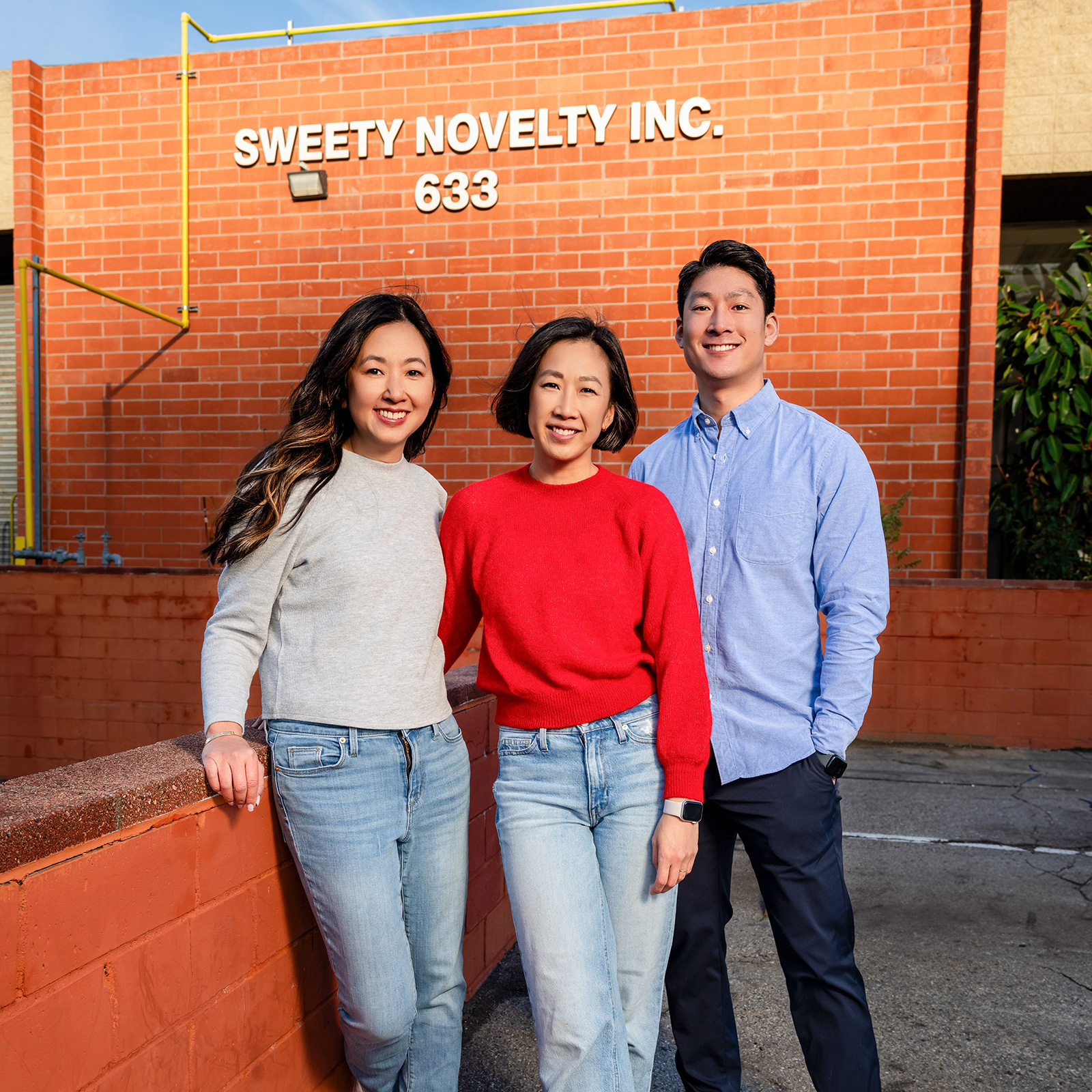 The founders of Sweety together in front of sign