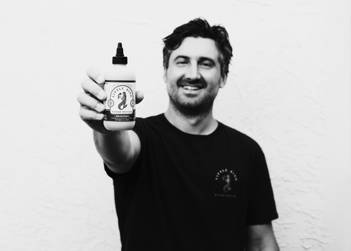 man holding mustard bottle